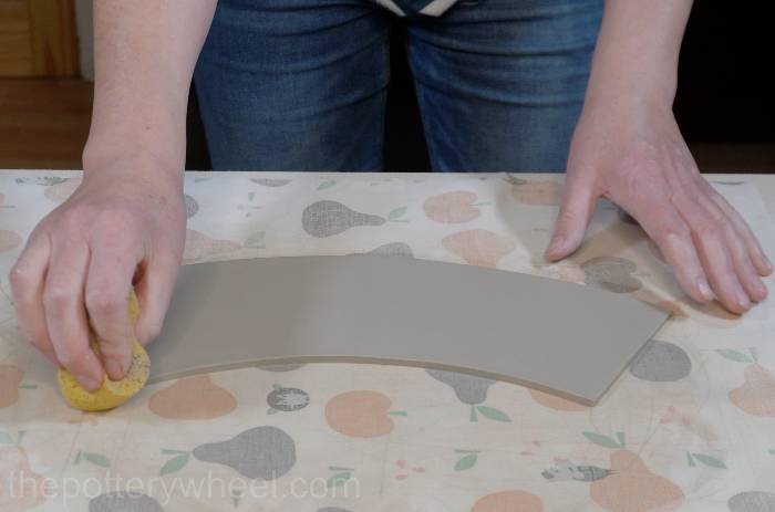 smoothing out the rim of the square bottomed slab mug