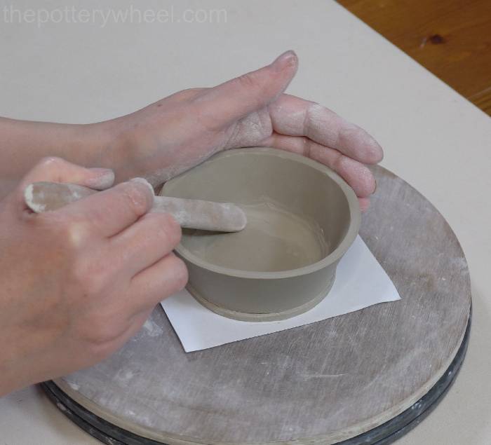 smoothing the coil in the bottom of the mug