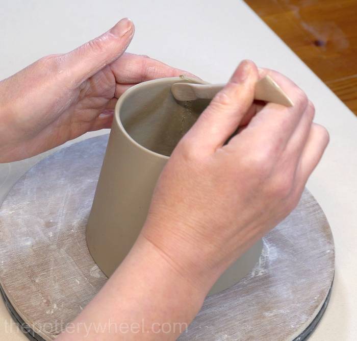 smoothing the inside seam of the mug