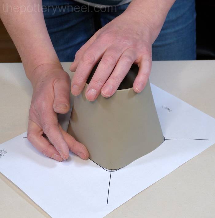 straightening the bottom sides of the mug