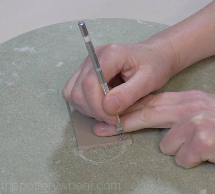 scoring the edges of the clay