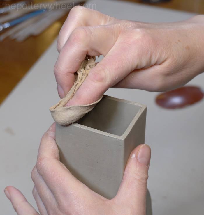 smoothing the neck of the donut vase