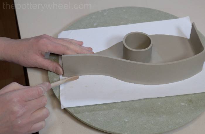 smoothing the outside of the vase