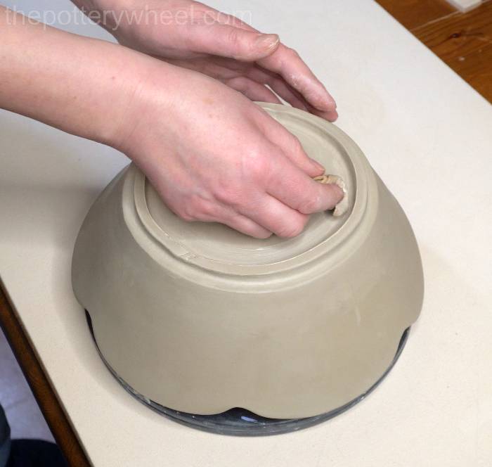 Smoothing down the foot ring on the bowl