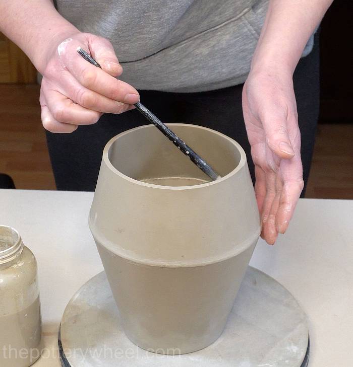 applying slip to the inside join of the jug