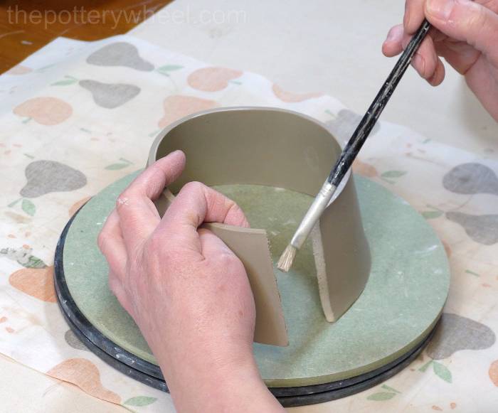 applying slip to the shoulder of the jug