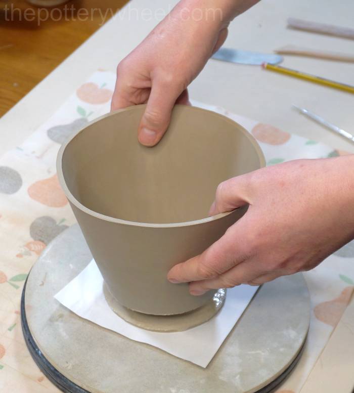 lowering the bottom of the mug into place