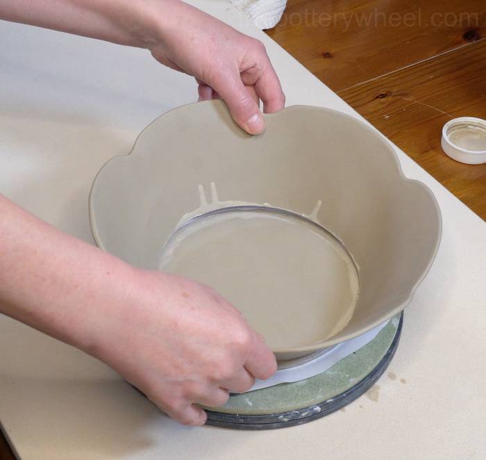 lowering the bowls onto the base