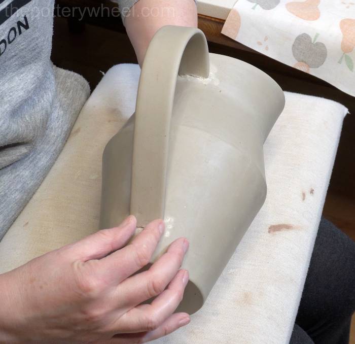 pressing the handle onto the jug