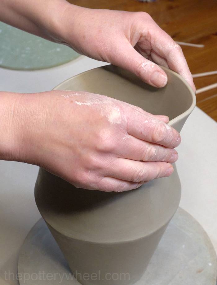 shaping the rim of the jug some more