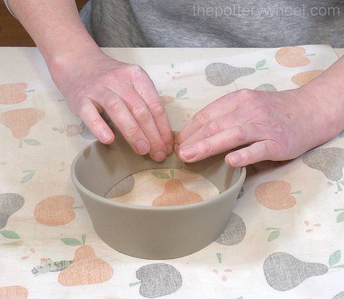 shaping the rim of the jug