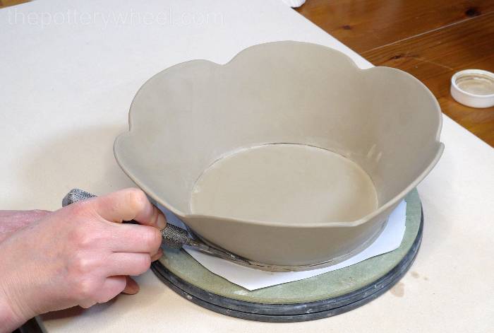 trimming the edge off the base of the bowl