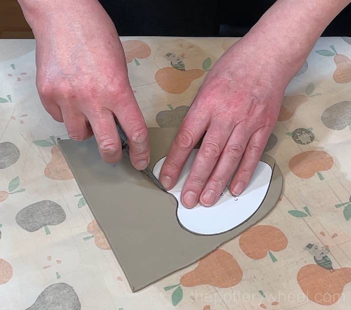 cutting out the base of the heart shaped slab pottery mug