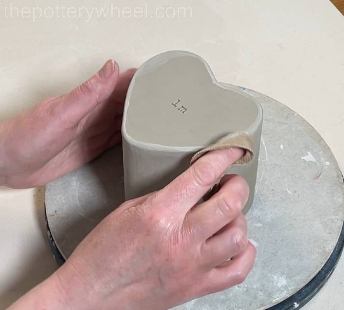 smoothing the base of the heart shaped slab mug