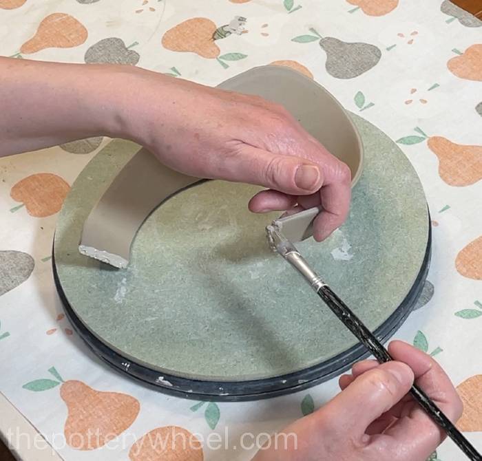 applying slip to the short edge of the rim