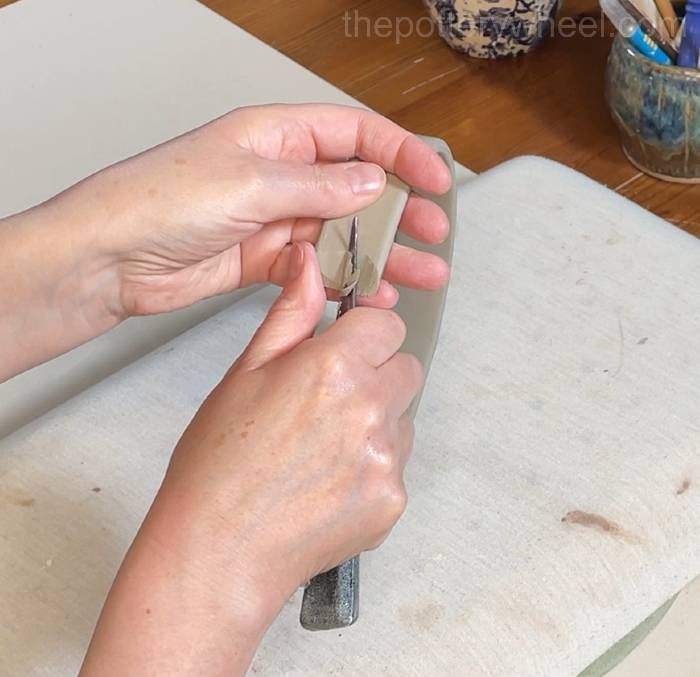 cutting a concave shape on the slab pottery vase handle