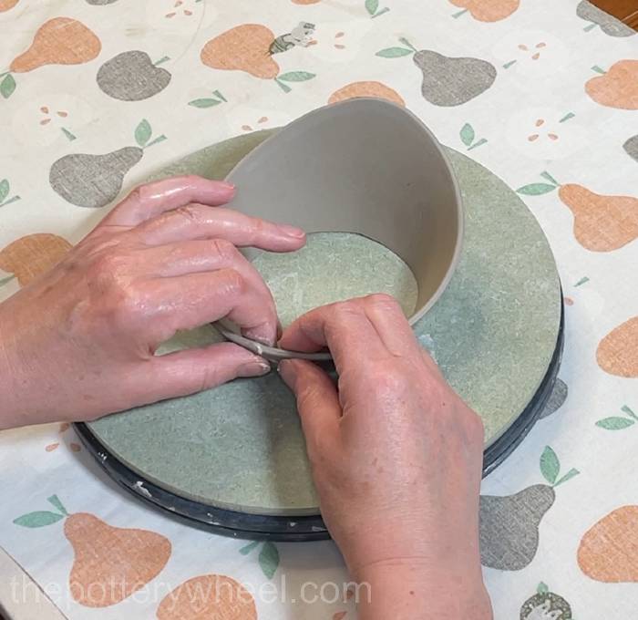 pressing the edges of the clay slab together