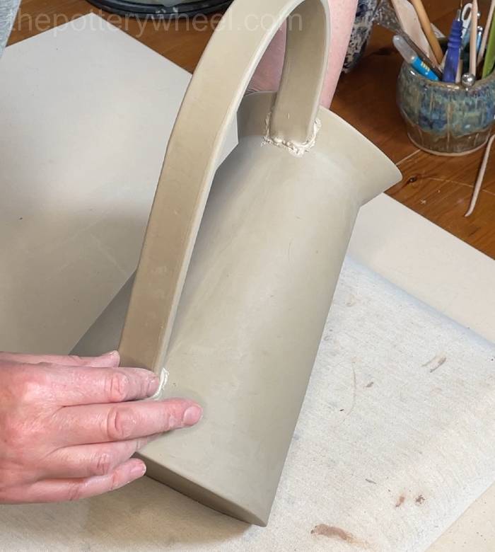 pressing the handle onto the flower jug vase