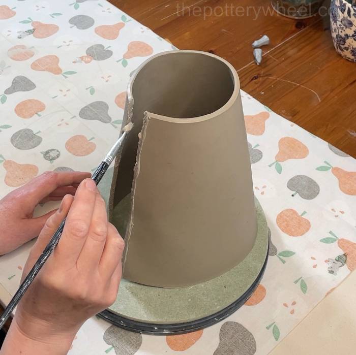 putting slip on the clay slab