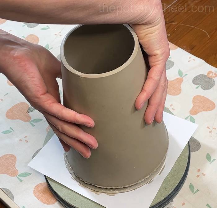 putting the bottom of the slab pottery vase onto the base