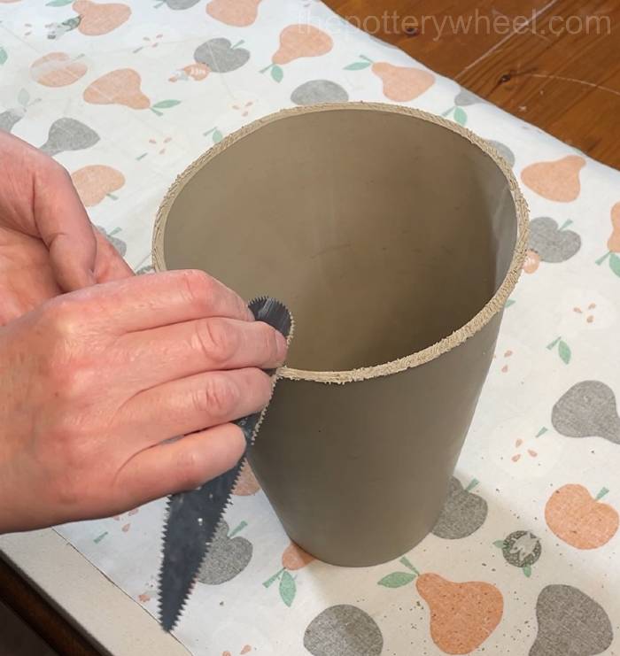 scoring the bottom edge of the flower jug vase