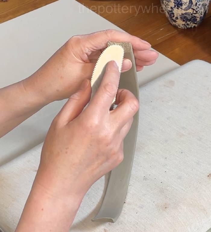 scoring the end of the flower jug vase handle