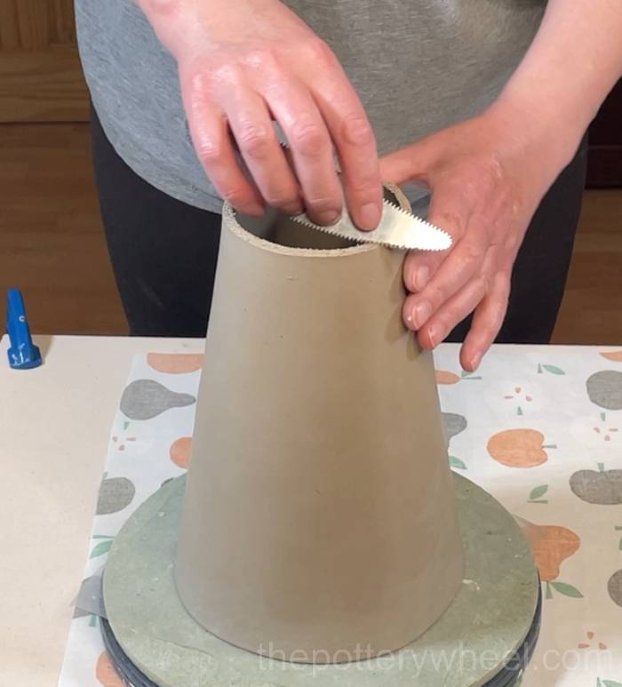scoring the top edge of the flower jug vase