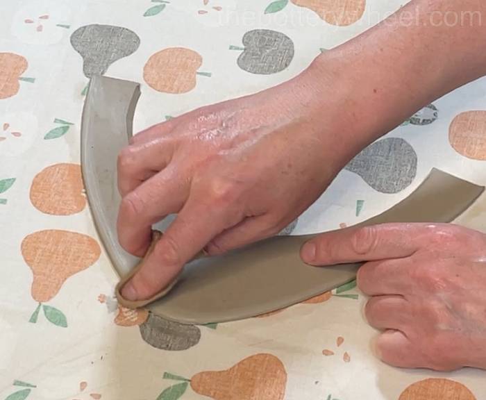 smoothing the rim of the flower jug vase