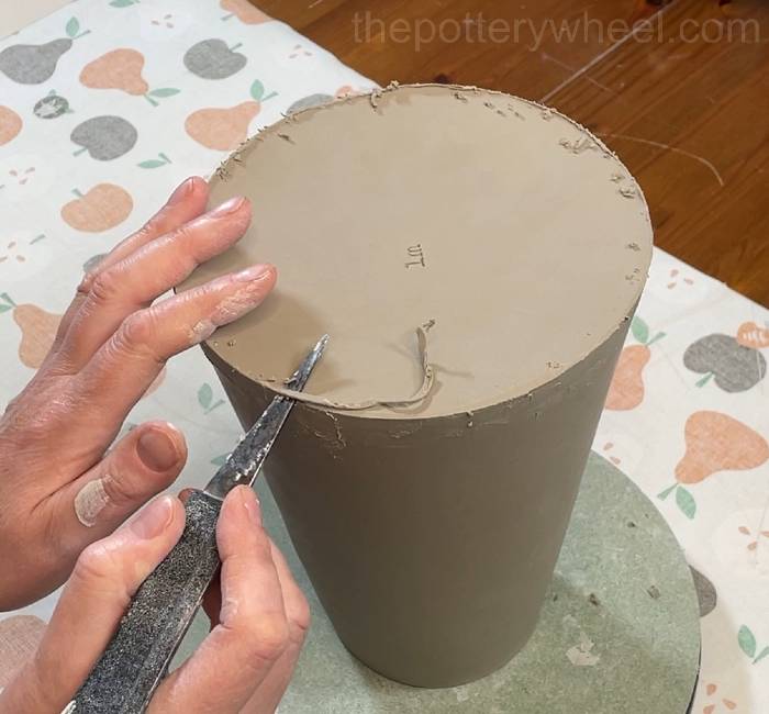 trimming the base of the flower jug vase