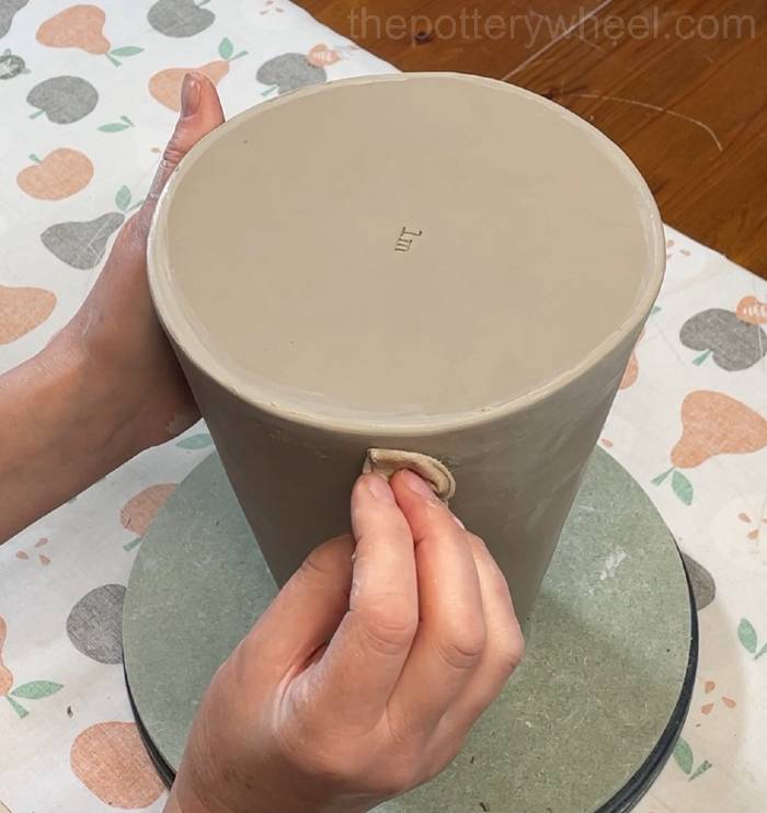 wiping down the base of the flower jug vase