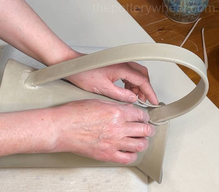 wrapping a coil around the handle on the flower jug vase