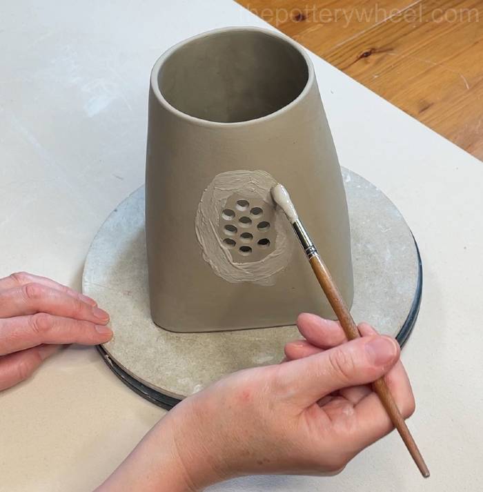 applying slip to attach the spout