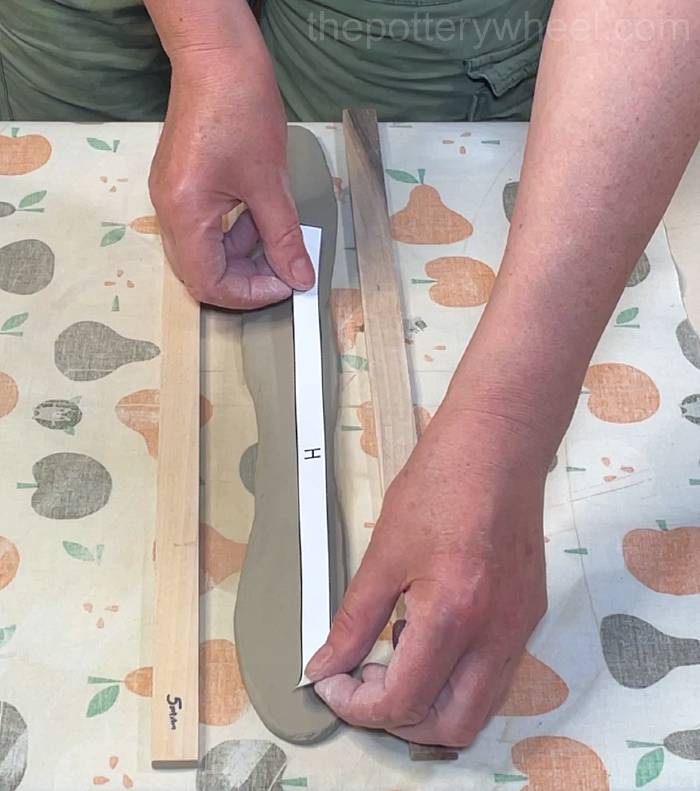 cutting the rim of the teapot lid