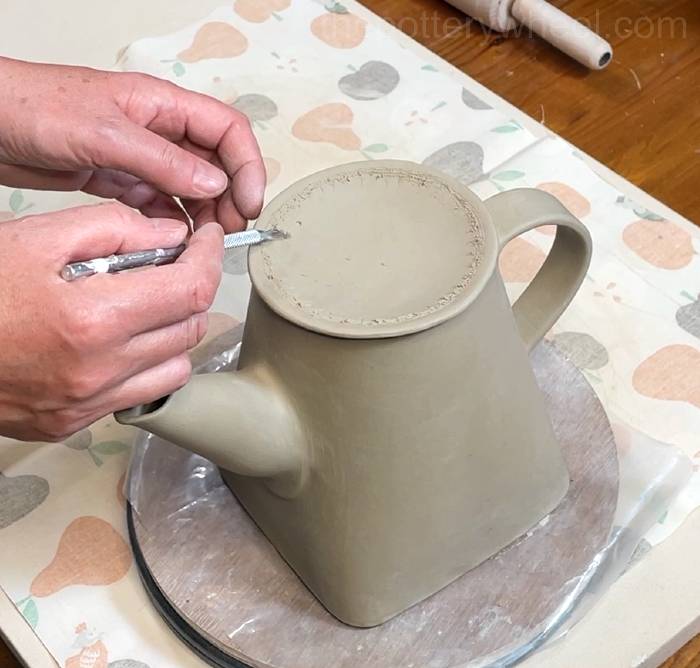 scoring the underside of the teapot lid