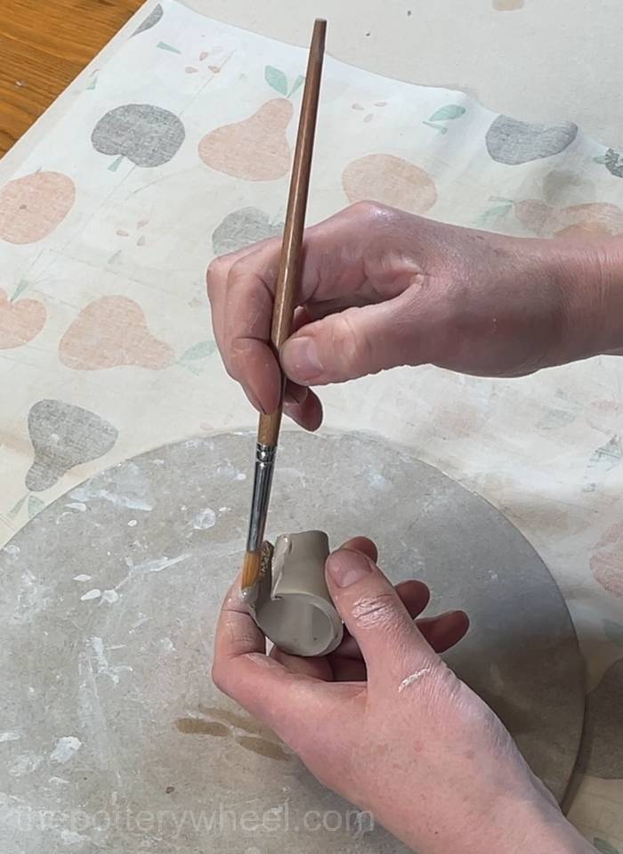 Applying slip on the edge of the spout