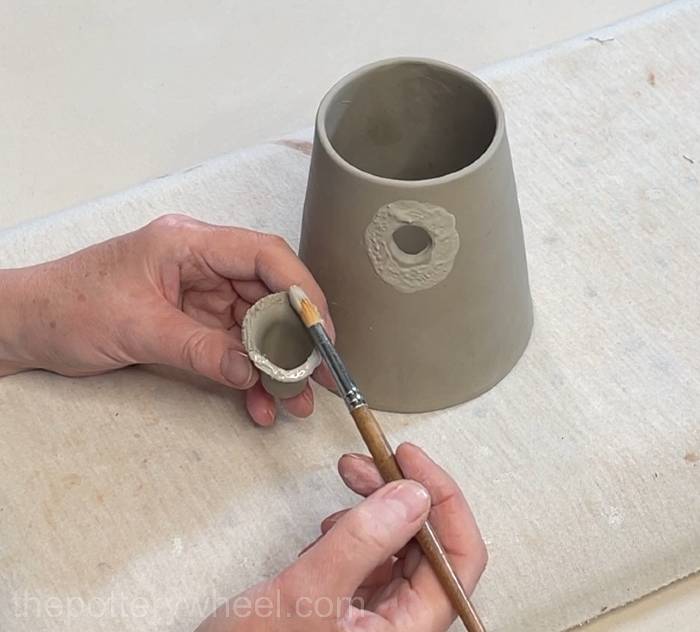 Applying slip to both scored surfaces