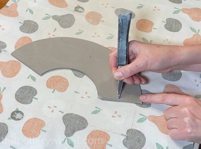 Bevelling the edges of the clay slab