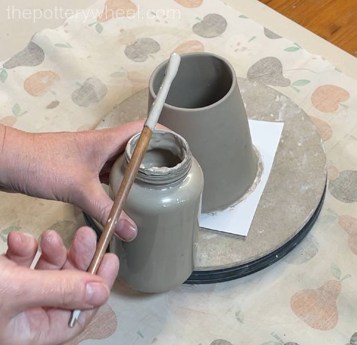 Loading the brush with clay slip