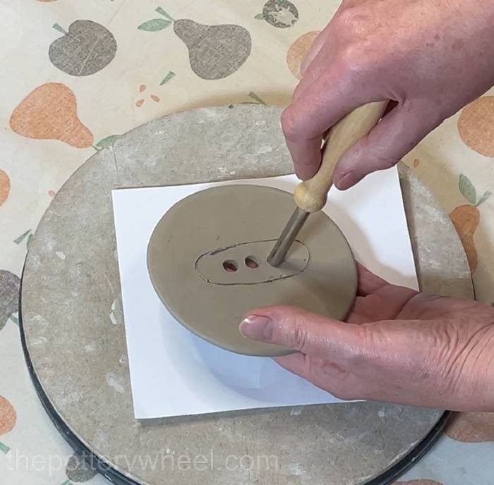 Making holes with the clay hole cutter