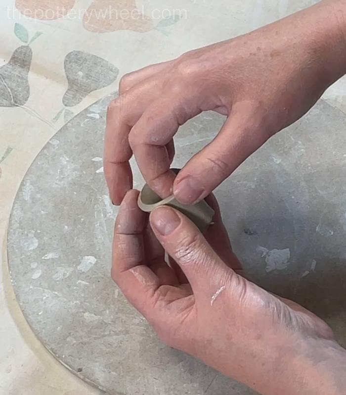 Pressing the edges of the spout together
