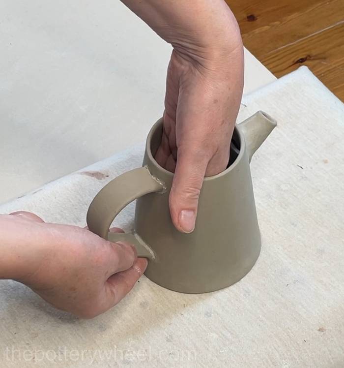 Pressing the handle onto the pour-over coffee dripper jug