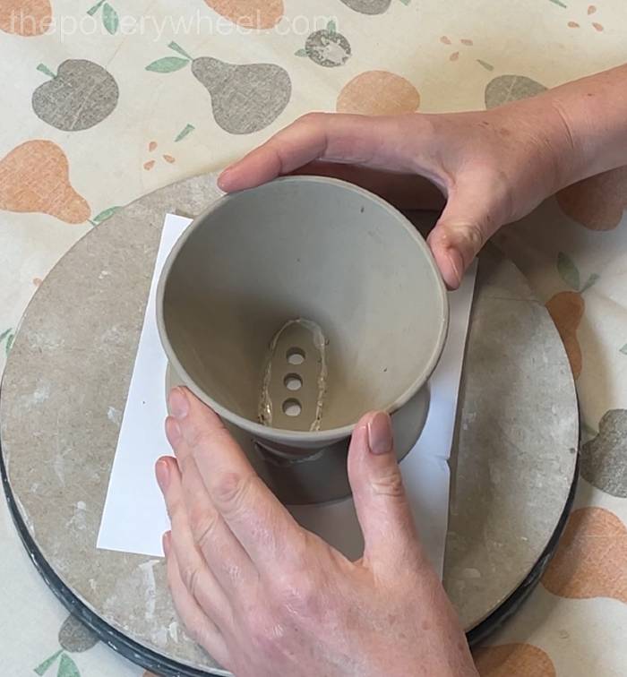 Pressing the top of the coffee dripper in place