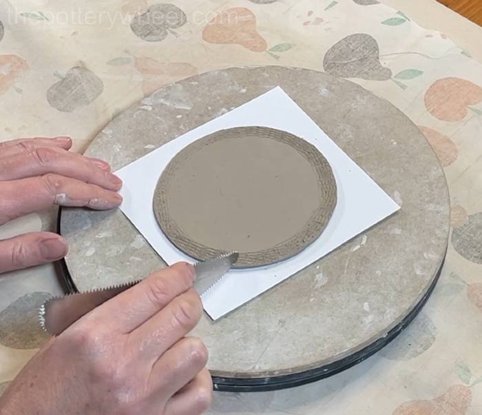 Score around the edge of the pour over coffee dripper base