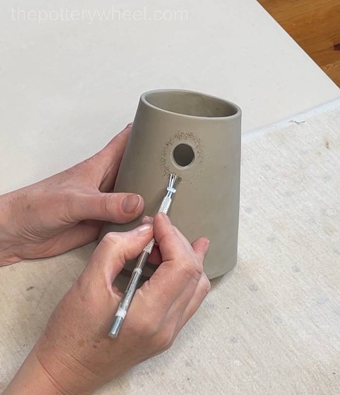 Scoring around the edge of the spout hole