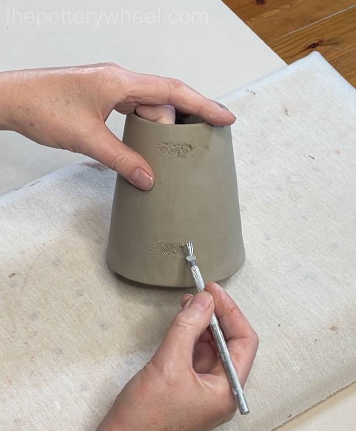 Scoring the coffee just where the clay handle will attach