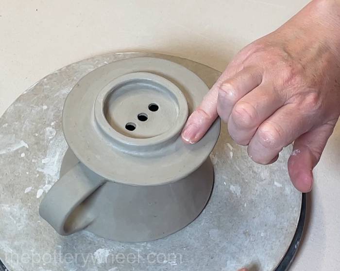 Smoothing the clay flange