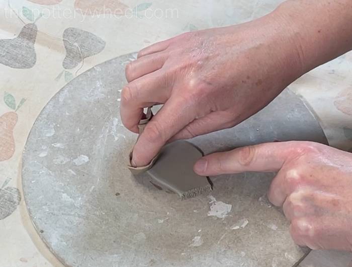 Smoothing the rim of the spout