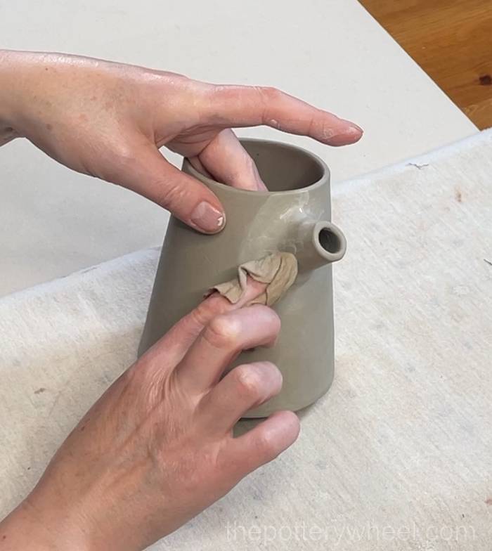 Wiping down the spout on the pour-over coffee dripper