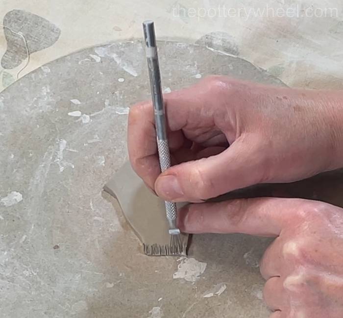 scoring the edge of the spout