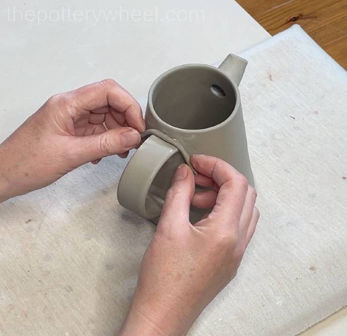 wrapping a clay coil around the handle